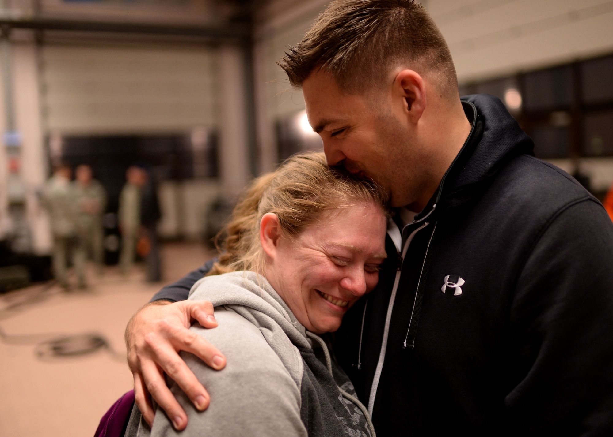 U.S. Air Force Capt. Bryan Grigas, right, 606th Air Control Squadron, comforts his wife, Terra, Oct. 7, 2014, at Spangdahlem Air Base, Germany, prior to his deployment to Southwest Asia. The squadron Airmen maintain equipment worth more than $170 million to provide airspace control to combatant commanders. (U.S. Air Force photo by Staff Sgt. Daryl Knee/Released)
