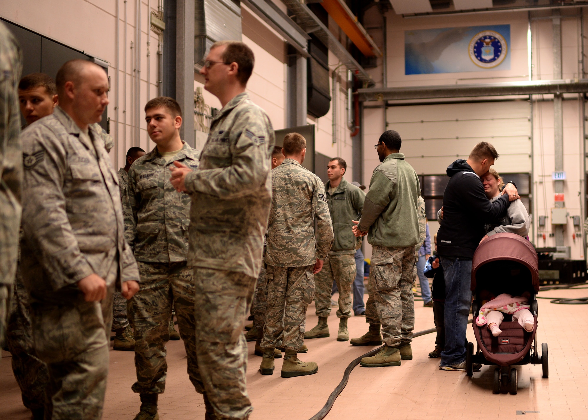 U.S. Air Force Capt. Bryan Grigas, 606th Air Control Squadron, holds his wife, Terra, Oct. 7, 2014, at Spangdahlem Air Base, Germany, prior to a deployment to Southwest Asia. The squadron trains throughout the year to provide combatant commanders with persistent long-range radar, data links and radio communication.  (U.S. Air Force photo by Staff Sgt. Daryl Knee/Released)