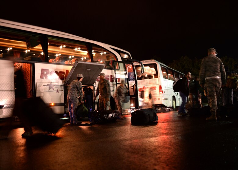 U.S. Air Force Airmen assigned to the 606th Air Control Squadron prepare to board buses Oct. 7, 2014, at Spangdahlem Air Base, Germany, prior to their departure for Southwest Asia. The bus drivers transported the Airmen to the airfield from which they departed. (U.S. Air Force photo by Staff Sgt. Daryl Knee/Released)