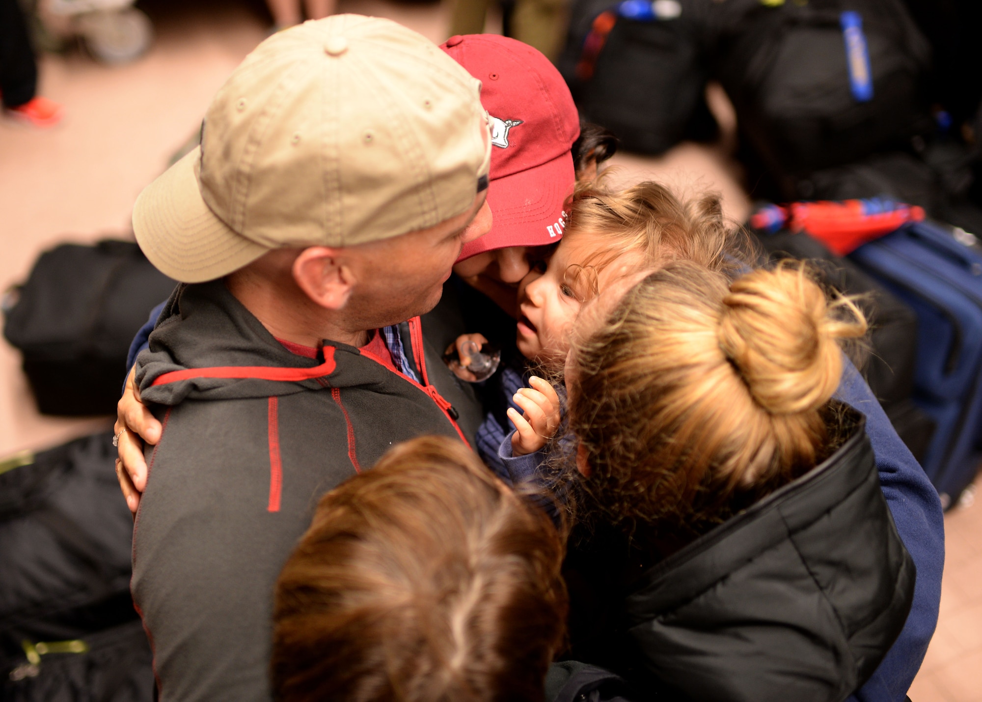 U.S. Air Force Capt. Eric Thonvold, 606th Air Control Squadron, hugs his family Oct. 7, 2014, at Spangdahlem Air Base, Germany, before departing for Southwest Asia in support of Operation Enduring Freedom. The airspace control they provide affects operations ranging from combat to transportation. (U.S. Air Force photo by Staff Sgt. Daryl Knee/Released)