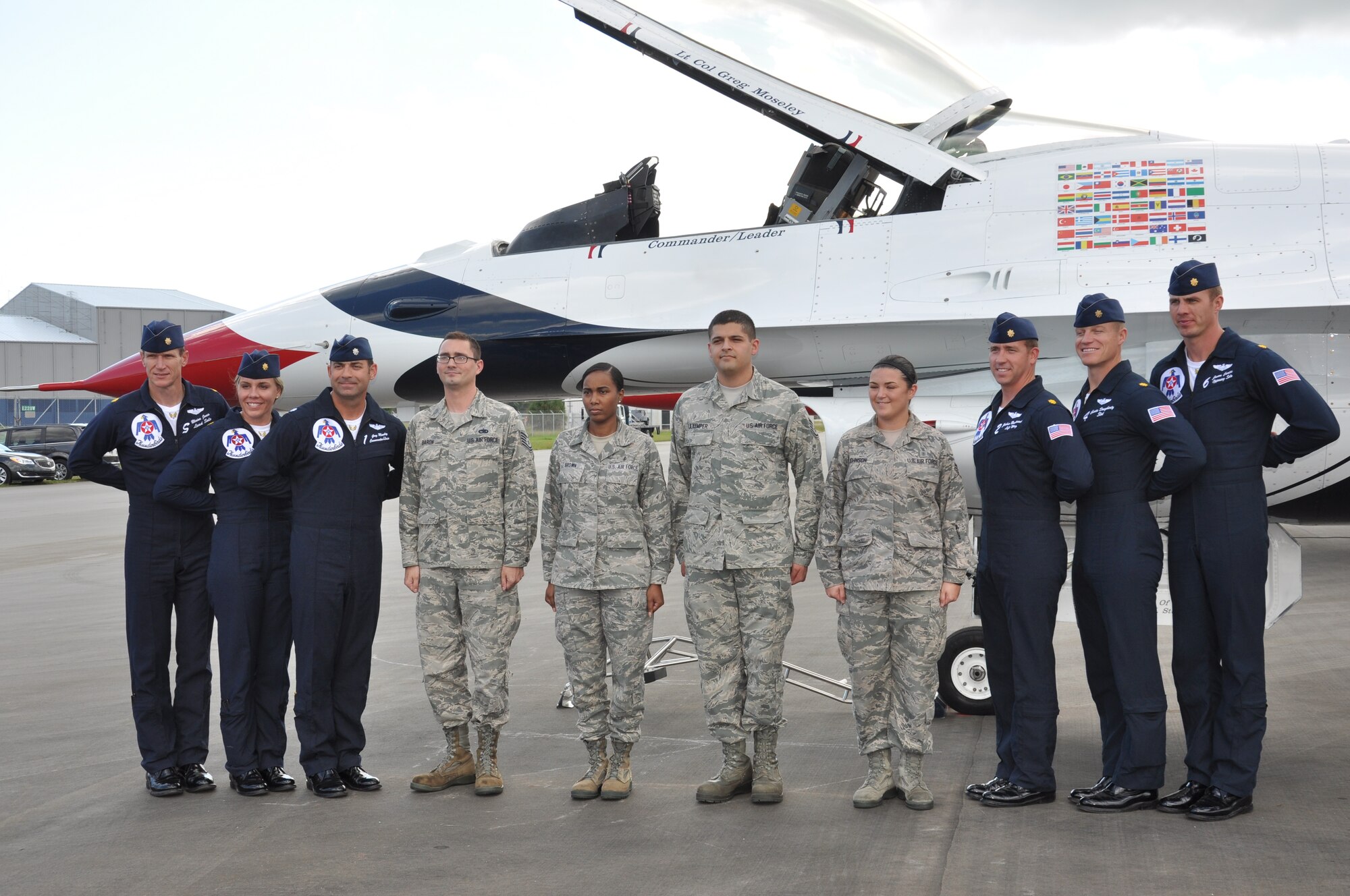 Members of the 45th Space Wing and Air Force Technical Applications Center, pose for a photo with members of the U.S. Air Force Thunderbirds, Oct. 3, 2014, after a reenlistment ceremony at the Melbourne Air & Space Show, Melbourne, Fla. Also in attendance were friends and family who were invited by the Thunderbirds to watch their practice performance, which took off immediately following the reenlistment ceremony.  (U.S. Air Force photo/Shawn M. Walleck) (Released)