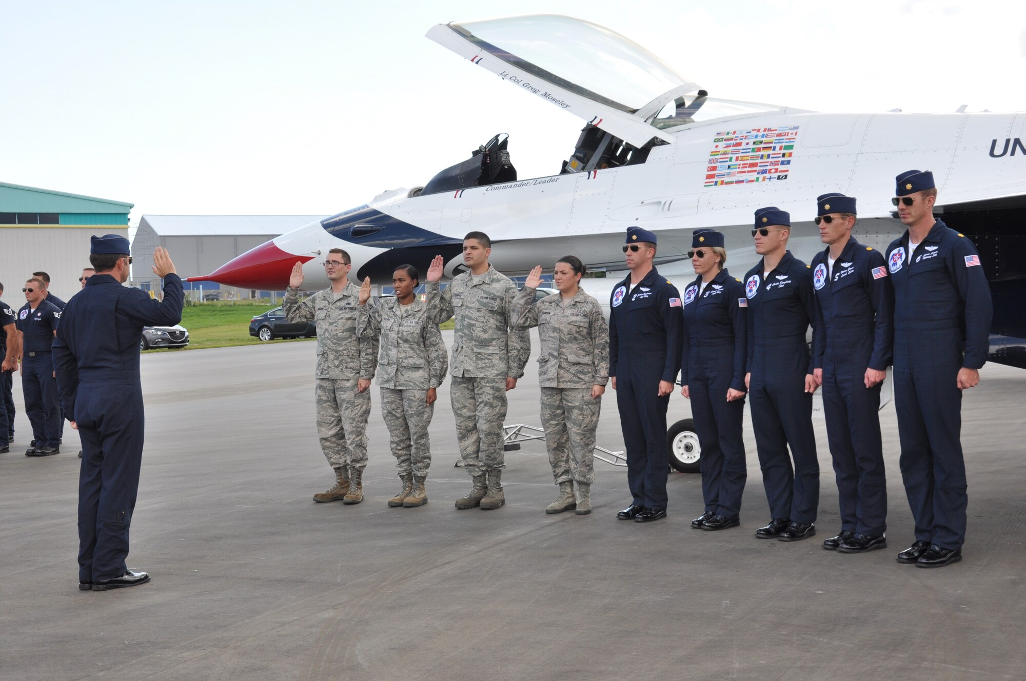 Lt. Col. Greg Moseley, U.S. Air Force Thunderbird commander, (left) administers the oath of enlistment to members of the 45th Space Wing and Air Force Technical Applications Center, Oct. 3, 2014, as part of the events leading up to the Melbourne Air & Space Show, Melbourne, Fla. In attendance were friends and family who were invited by the Thunderbirds to watch their practice performance, which took off immediately following the reenlistment ceremony.  (U.S. Air Force photo/Shawn M. Walleck) (Released)