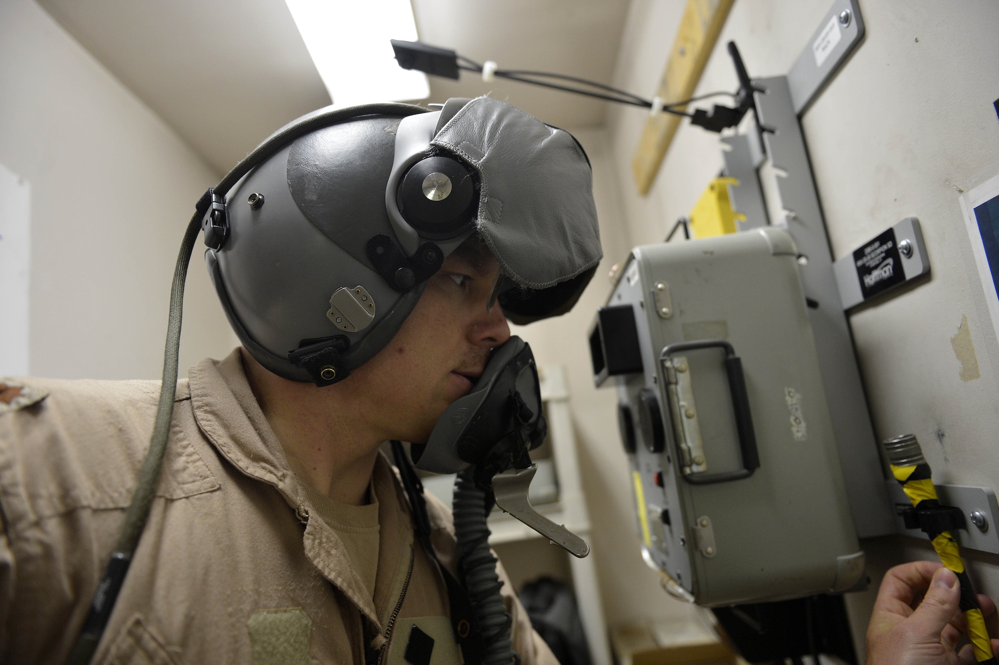 U.S. Air Force Maj. Vincent Sherer, 455th Air Expeditionary Wing pilot, checks his equipment before a sortie at Bagram Airfield, Afghanistan Aug. 5, 2014. Sherer flies the A-10 Thunderbolt II to provide overwatch and close air support to ground forces. He is deployed from Davis-Monthan Air Force Base, Ariz. and a native of Portland, Ore. (U.S. Air Force photo by Staff Sgt. Evelyn Chavez/Released)
