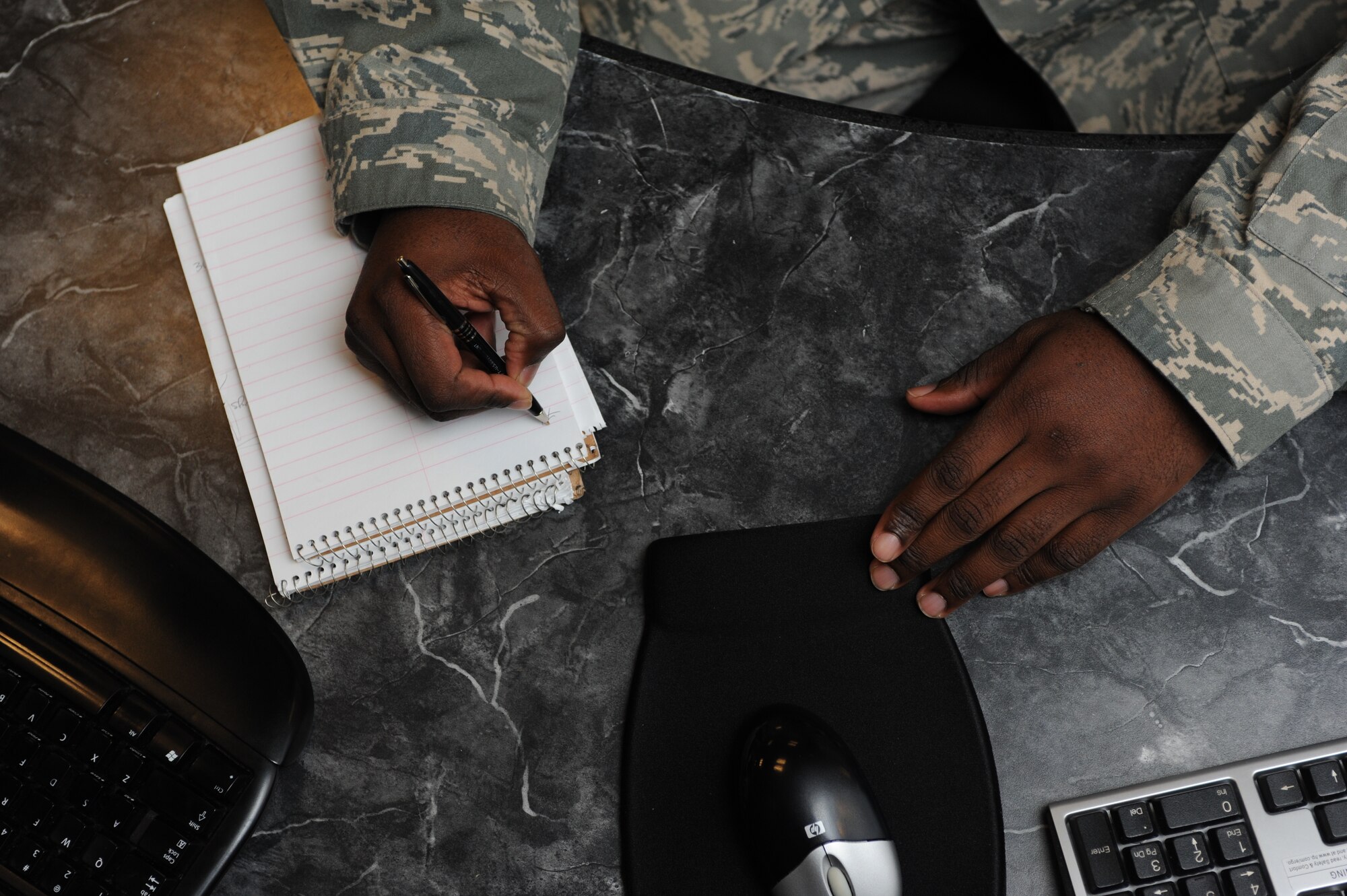 Master Sgt. Kelly Barrett, 5th Bomb Wing NCO in charge of command and control operations, takes notes in the command post on Minot Air Force Base, N.D., Oct. 3, 2014. The Kansas native began his career in 1996 and has worked at a variety of locations, as part of command and control, including a munitions site in the Netherlands. (U.S. Air Force photo/Senior Airman Stephanie Morris)