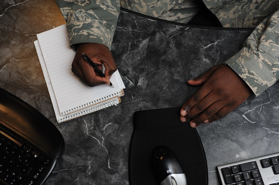 Master Sgt. Kelly Barrett, 5th Bomb Wing NCO in charge of command and control operations, takes notes in the command post on Minot Air Force Base, N.D., Oct. 3, 2014. The Kansas native began his career in 1996 and has worked at a variety of locations, as part of command and control, including a munitions site in the Netherlands. (U.S. Air Force photo/Senior Airman Stephanie Morris)