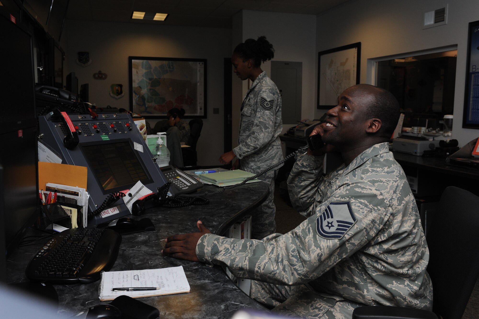 Master Sgt. Kelly Barrett, 5th Bomb Wing NCO in charge of command and control operations, answers a phone in the command post on Minot Air Force Base, N.D., Oct. 3, 2014. Barrett has worked in various command posts since 1996 and has lead and taught his peers since he was a senior Airman. (U.S. Air Force photo/Senior Airman Stephanie Morris)