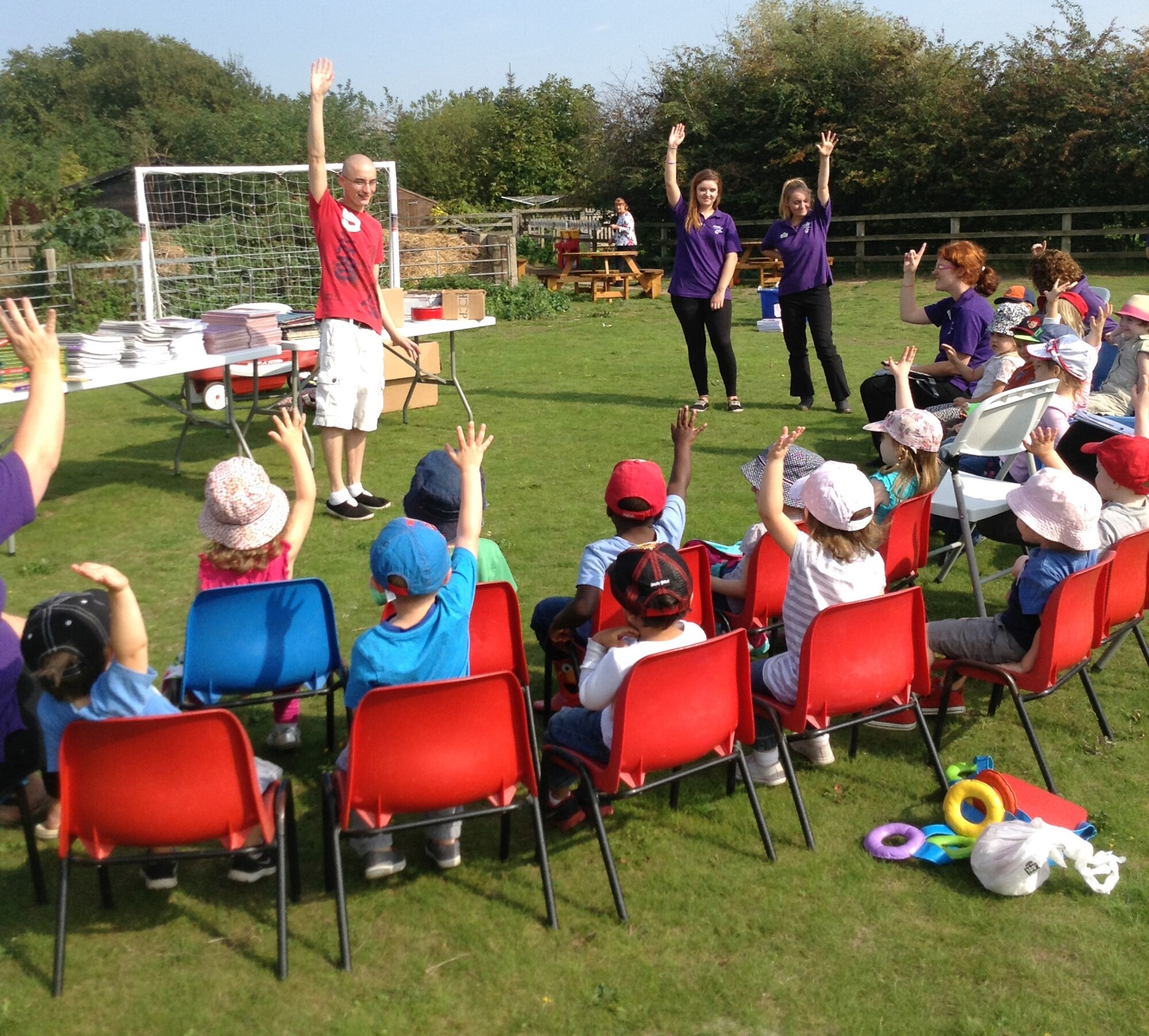 U.S. Air Force Staff Sgt. Mathew Donathan, fourth from left, 727th Air Mobility Squadron safety NCO in charge from Jefferson, Ohio, speaks to children after donating supplies to them Sept. 18, 2014, at the Busy Bees Nursery in Beck Row, England. Donathan raised more than $1,100 worth of supplies for the children there. (Courtesy photo/Released)
