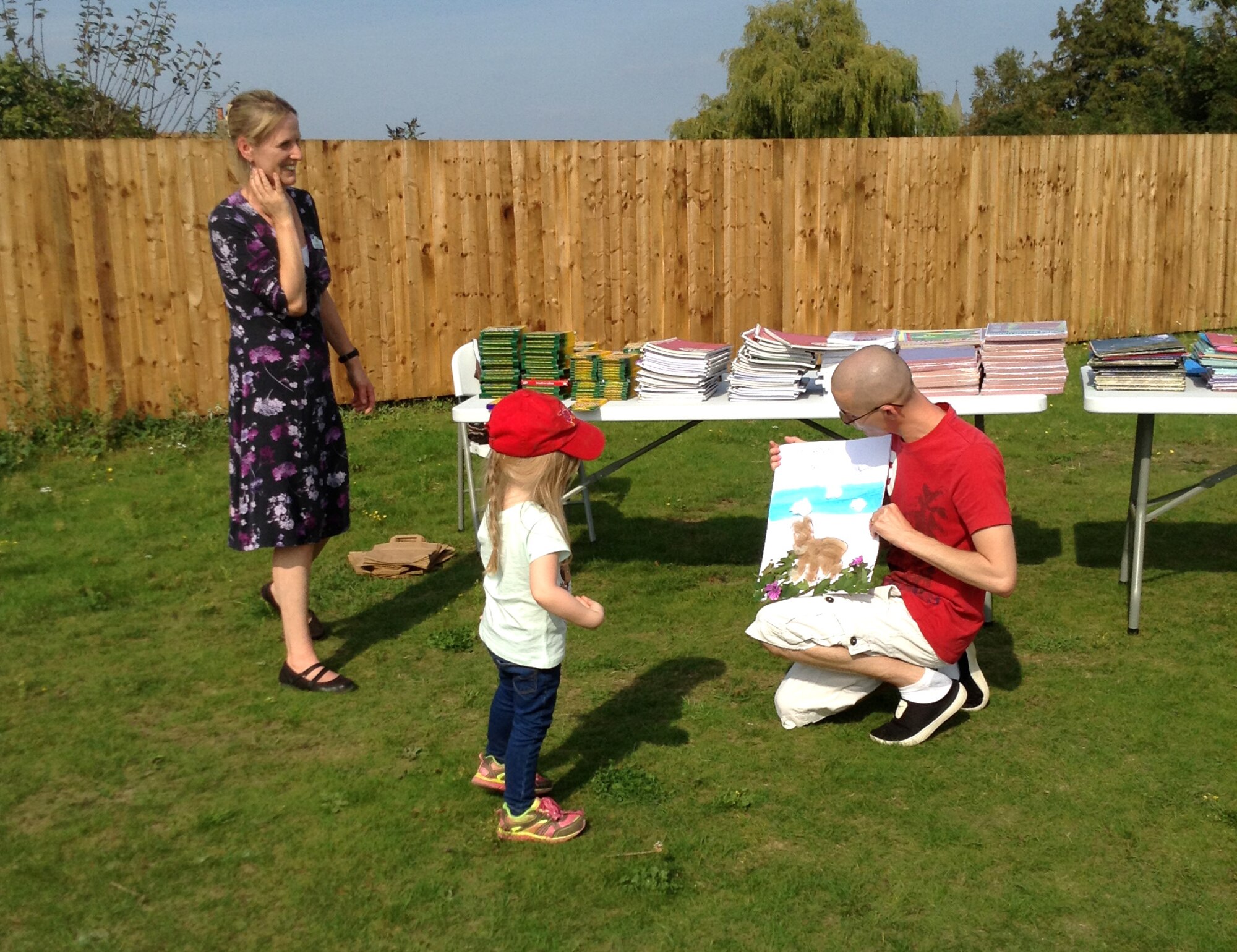 U.S. Air Force Staff Sgt. Mathew Donathan, right, 727th Air Mobility Squadron safety NCO in charge from Jefferson, Ohio, is presented with a thank you card for his school supply donations Sept. 18, 2014, at the Busy Bees Nursery in Beck Row, England. Donathan raised more than $1,100 worth of supplies for the children there. (Courtesy photo/Released)