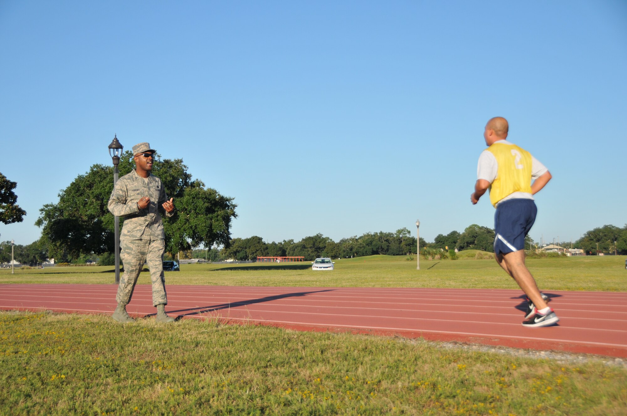 Chief Master Sgt. Cameron Kirksey, Air Force Reserve Command command chief, cheers on Airmen finishing their fitness tests during his visit to Keesler, Air Force Base. (U.S. Air Force photo/Senior Airman Nicholas Monteleone)