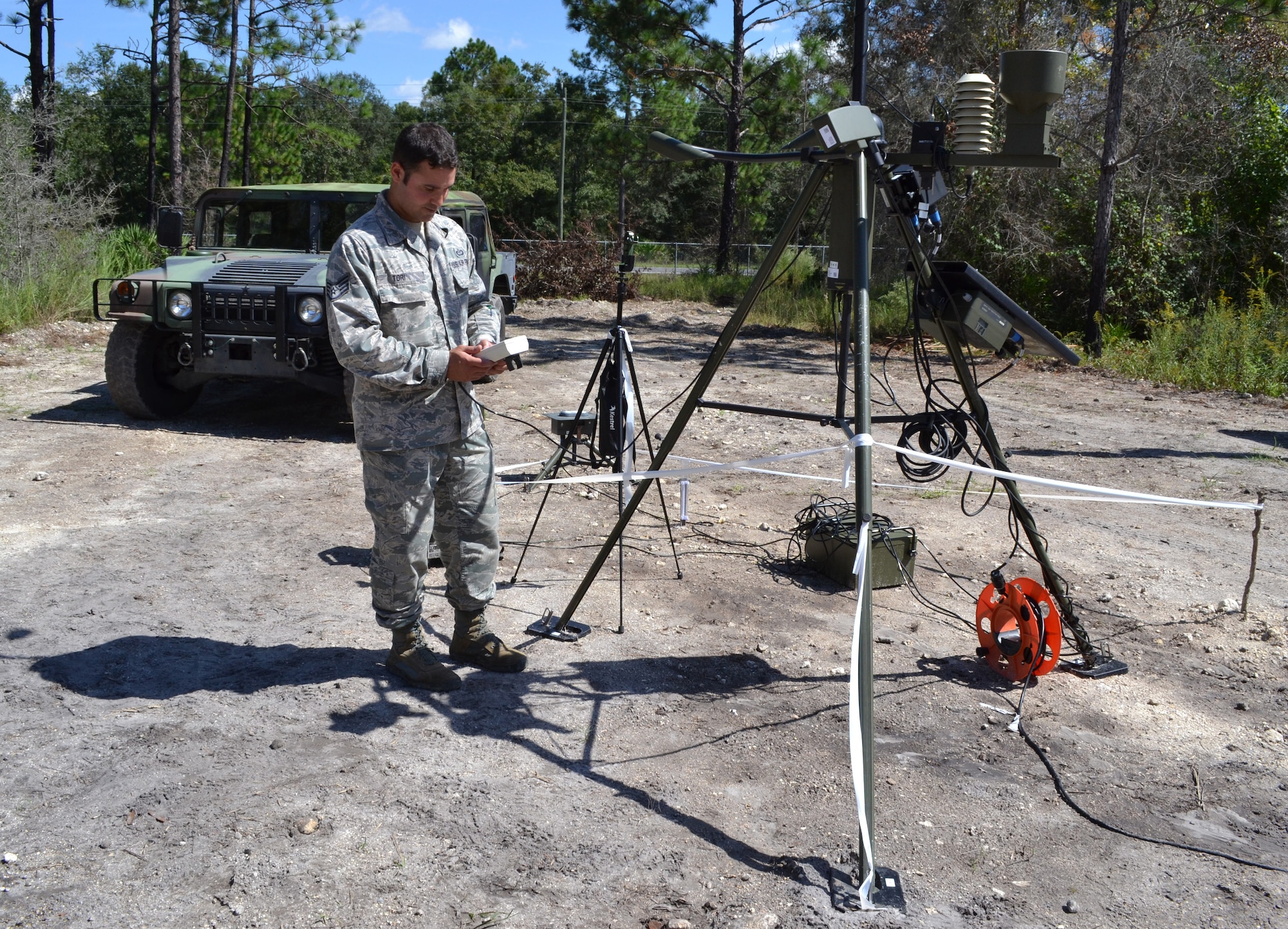 Staff Sgt. Phil Tori demonstrates operation of the handheld weather monitoring equipment during an Field Training Exercise Oct. 4, 2014 at the Camp Blanding Joint Training Center, Starke Fla. The FTX provided colaborative trainign between the 159th Weather Flight and the 290th Joint Communications Support Squadron. (U.S. Air National Guard photo by Tech. Sgt. William Buchanan)