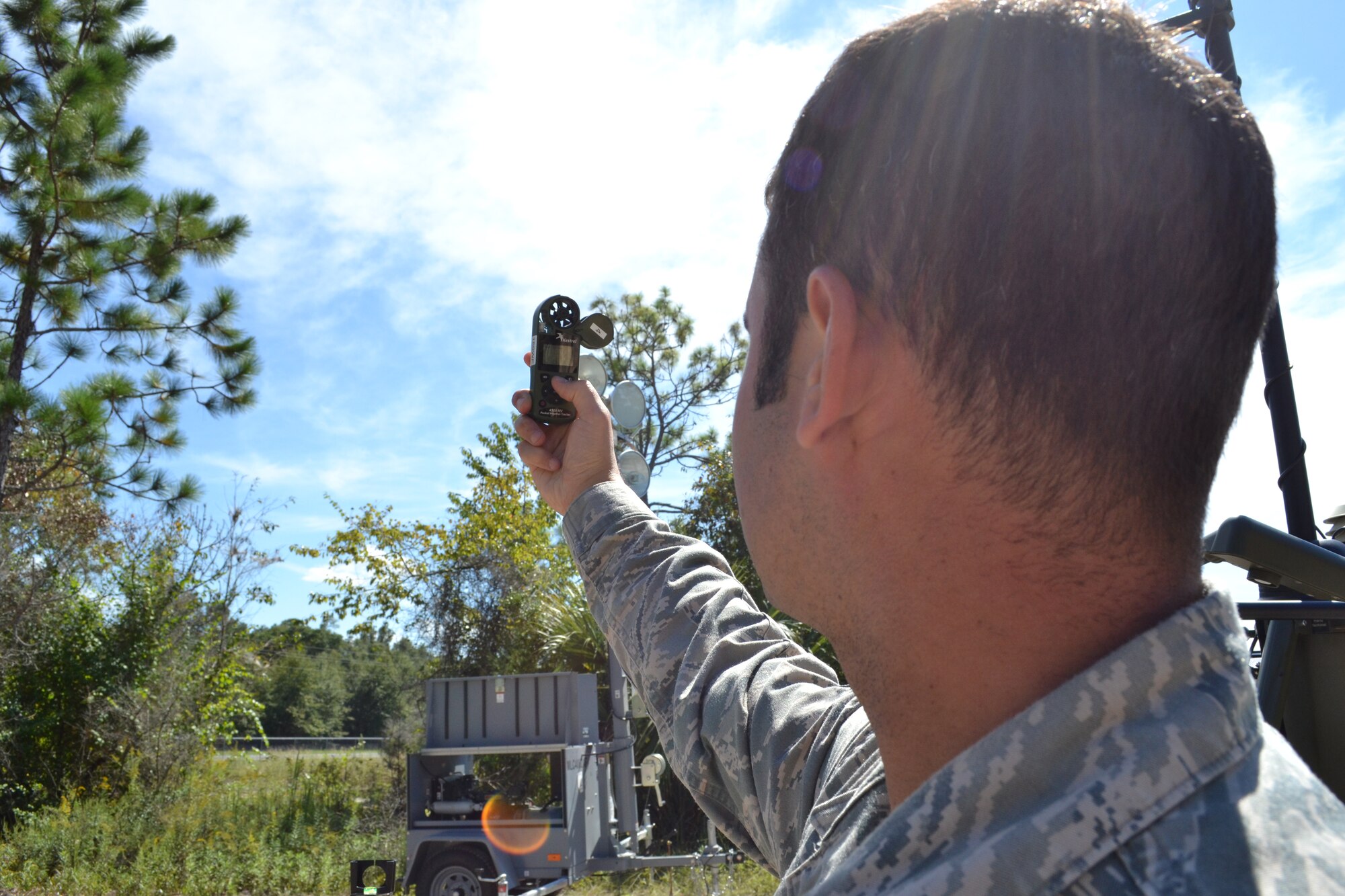 Staff Sgt. Phil Tori demonstrates operation of the handheld weather monitoring equipment during an Field Training Exercise Oct. 4, 2014 at the Camp Blanding Joint Training Center, Starke Fla. The FTX provided colaborative trainign between the 159th Weather Flight and the 290th Joint Communications Support Squadron. (U.S. Air National Guard photo by Tech. Sgt. William Buchanan)