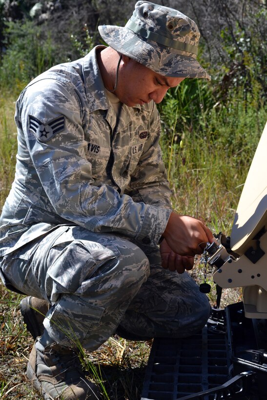 Senior Airman Kenneth Davis, a Cyper Transport Journeyman with the 290th Joint Communications Support Squadron, powers down a satellite dish during an Field Training Exercise Oct. 4, 2014 at the Camp Blanding Joint Training Center, Starke Fla. The FTX provided colaborative trainign between the 159th Weather Flight and the 290th Joint Communications Support Squadron. (U.S. Air National Guard photo by Tech. Sgt. William Buchanan)
