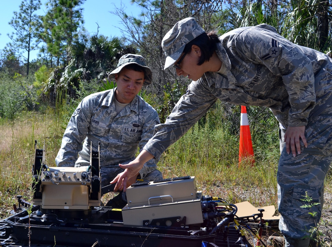 Airman 1st Class Caroline Alper and Senior Airman Kenneth Davis, Cyper Transport Journeyen with the 290th Joint Communications Support Squadron, power down a satellite dish during an Field Training Exercise Oct. 4, 2014 at the Camp Blanding Joint Training Center, Starke Fla. The FTX provided colaborative trainign between the 159th Weather Flight and the 290th Joint Communications Support Squadron. (U.S. Air National Guard photo by Tech. Sgt. William Buchanan)