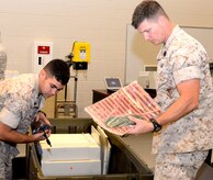 Petty Officer 3rd Class Garrett Minato (left) and Petty Officer 3rd Class Monty Perkins, both hospital corpsmen assigned to Medical Logistics Platoon, Detachment 3, prepare field X-ray units for shipment to Okinawa, Oct. 7, 2014, at the Marine Corps Reserve Center on Joint Base Charleston, S.C. MEDLOG, Detachment 3, Supply Company, Combat Logistics Battalion 451, recently celebrated their one-year anniversary at Joint Base Charleston since the unit was established in October 2013. (U.S. Air Force photo/Eric Sesit) 

