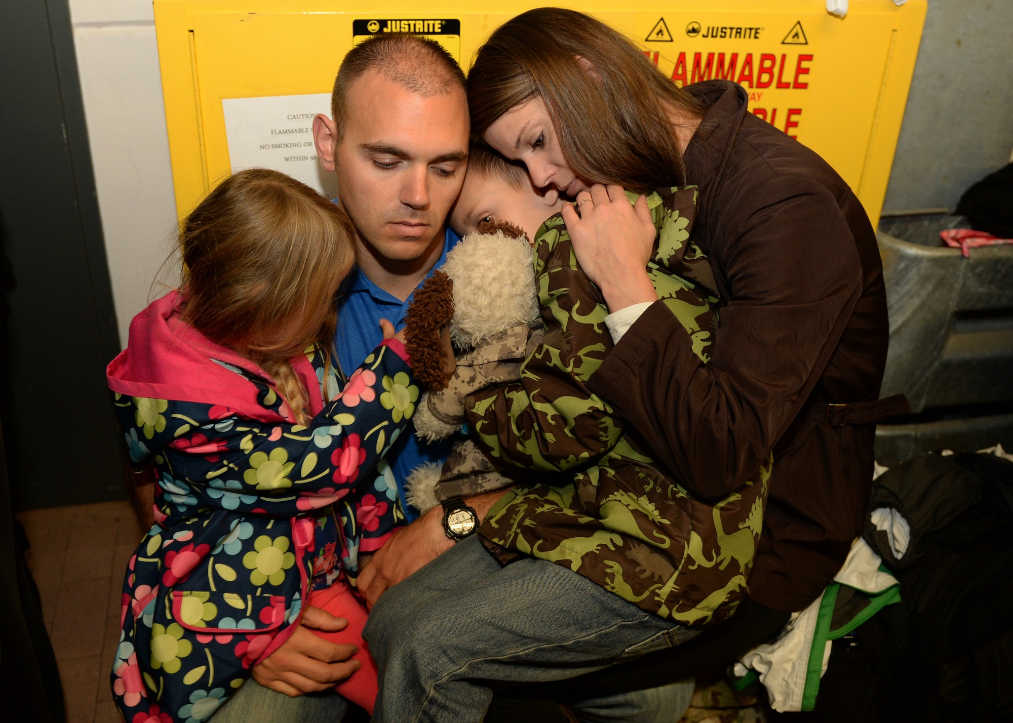 The Macri family embrace during a squadron deployment going away Oct. 7, 2014, at Spangdahlem Air Base, Germany. More than 300 people attended the event. (U.S. Air Force photo by Airman 1st Class Dylan Nuckolls/Released)