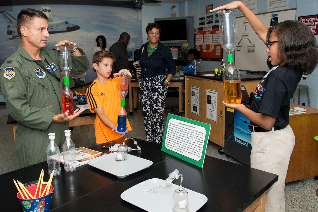 A STARBASE student leads an atmospheric demonstration prior to the start of a ceremony on Oct. 2, 2014, Barksdale Air Force Base, La. STARBASE, which is a premier Department of Defense Science, Technology, Engineering and Mathematics program sponsored by the 307th Bomb Wing, celebrated 15 years of service at Barksdale. (U.S. Air Force photo by Master Sgt. Greg Steele/Released)
