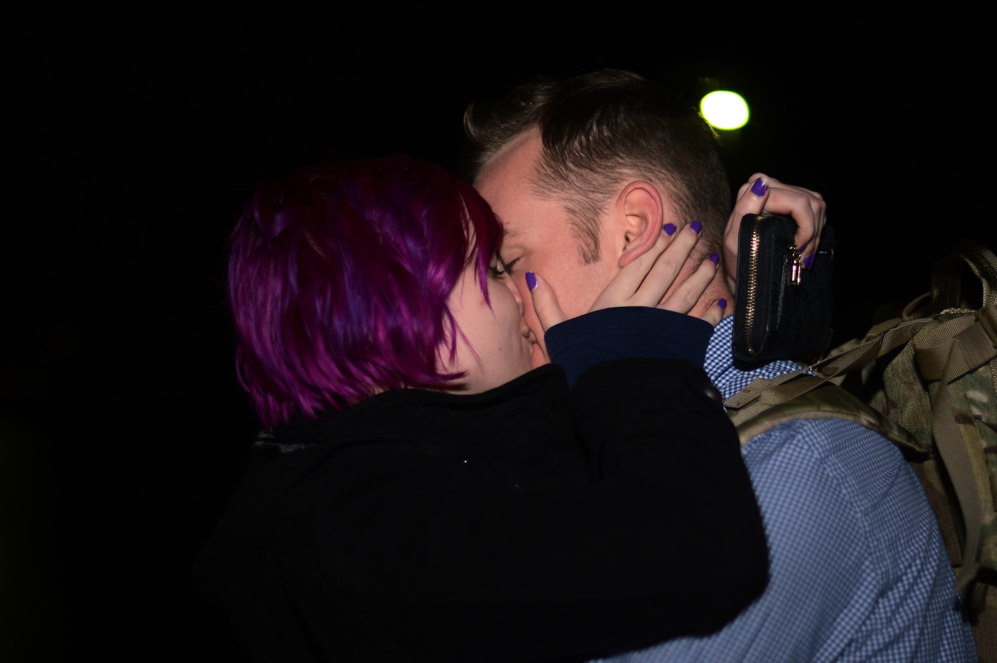 U.S. Air Force Senior Airman Julian Chesser, a 606th Air Control Squadron interface control technician and native of Prattville, Ala., right, kisses his fiancée, Kessia Unger, on Spangdahlem Air Base, Germany, Oct. 7, 2014, before departing for a deployment to an undisclosed location in Southwest Asia. Members of the 606th ACS departed for Southwest Asia to provide air defense of the Arabian Gulf in support of Operation Enduring Freedom. (U.S. Air Force photo by Senior Airman Gustavo Castillo/Released) 