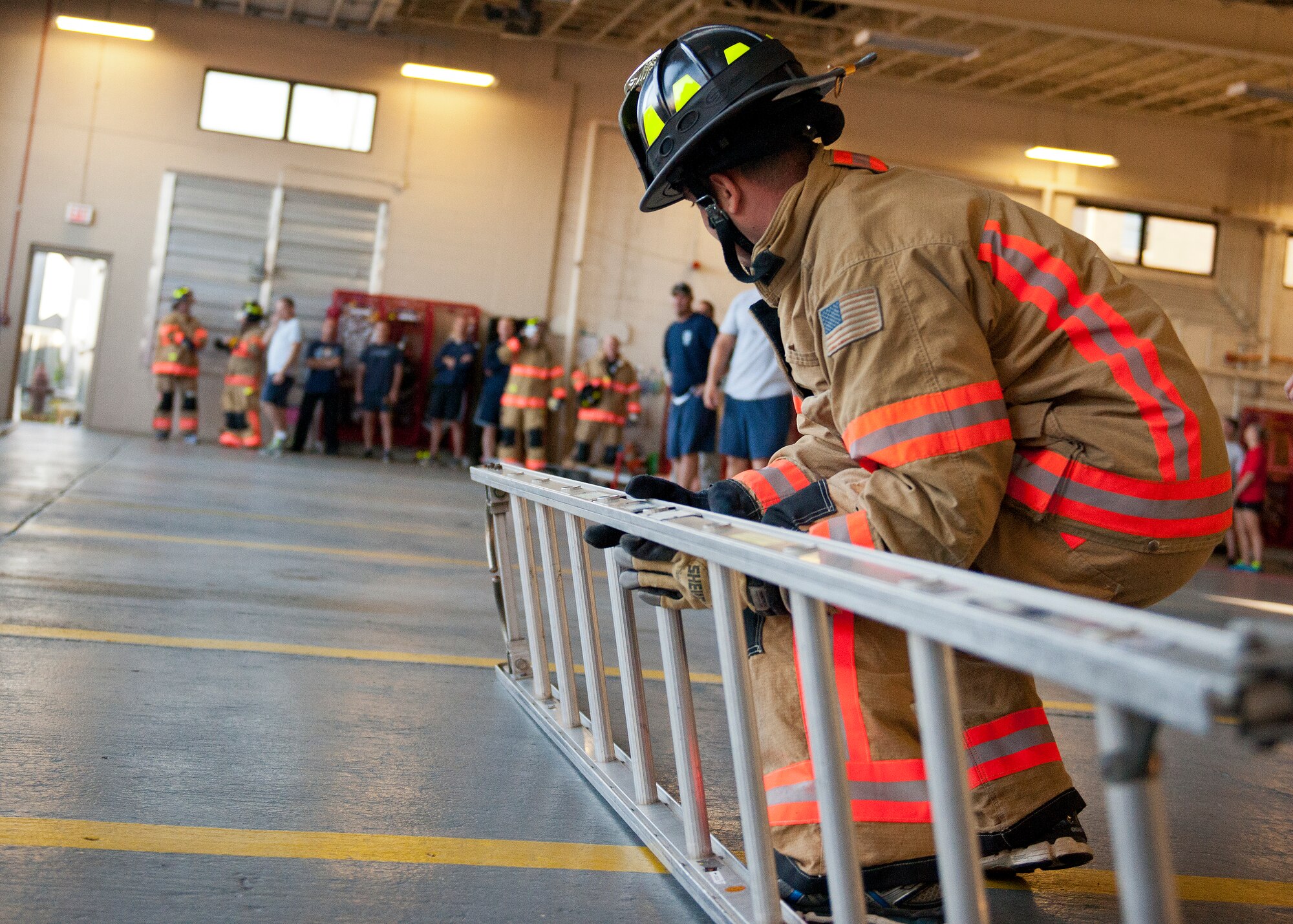 A participant picks up a ladder as part of the Chiefs versus Eagles Fire Prevention Week Challenge Oct. 6 at Eglin Air Force Base, Fla. Colonels and chief master sergeants raced through a series of firefighting physical activities to see who could finish first. The challenges included hose dragging, ladder climbing, victim carry and more. Four colonels and seven chiefs competed and their scores were averaged to determine the winner. The Eagles won by just over a second.  (U.S. Air Force photo/Samuel King Jr.)