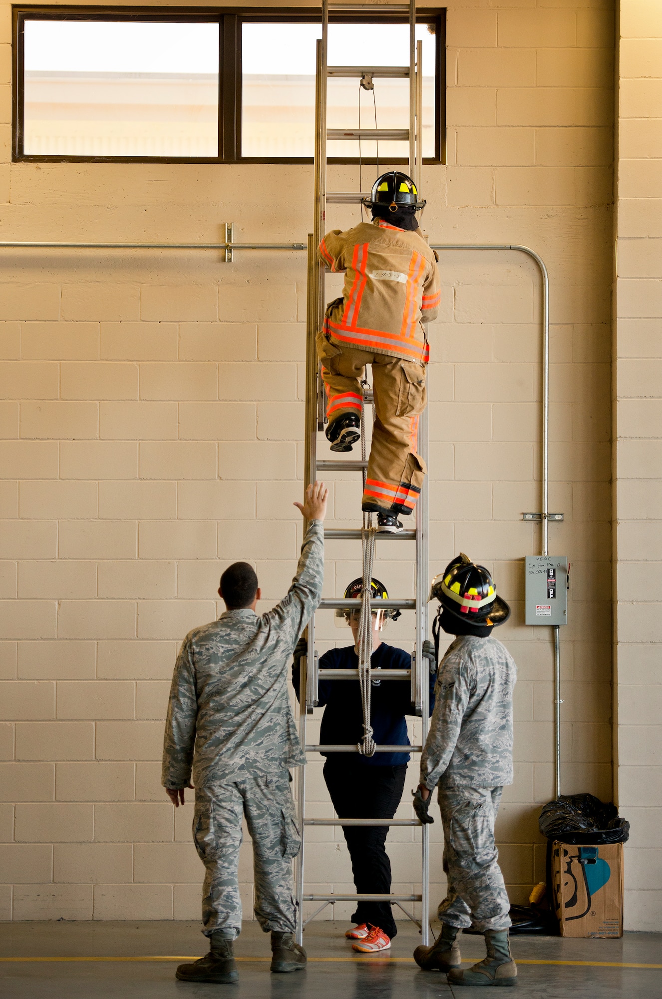 A participant climbs an extension ladder as part of the 1st Sergeants versus Squadron Commanders Fire Prevention Week Challenge Oct. 6 at Eglin Air Force Base, Fla. Participants raced through a series of firefighting physical activities to see who could finish first. The challenges included hose dragging, ladder climbing, victim carry and more. The 1st Sergeants won by a little more than two seconds.  (U.S. Air Force photo/Samuel King Jr.)
