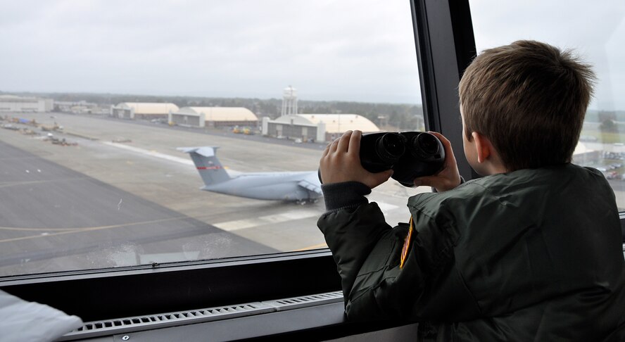 "Pilot for A Day" Peyton Malloy looks out onto the flight line from the control tower, Oct. 4, 2014 at Westover Air Force Reserve Base, Chicopee, Mass. “Pilot for a Day” is a program that provides high-spirited children like Peyton, who have serious or chronic conditions, and their families the unique opportunity to be guests of Westover and the U.S. Air Force. Peyton Malloy was accompanied by his mother Anne, father Robert, and sister Ashlyn. (U.S. Air Force photo/SrA. Monica Ricci)