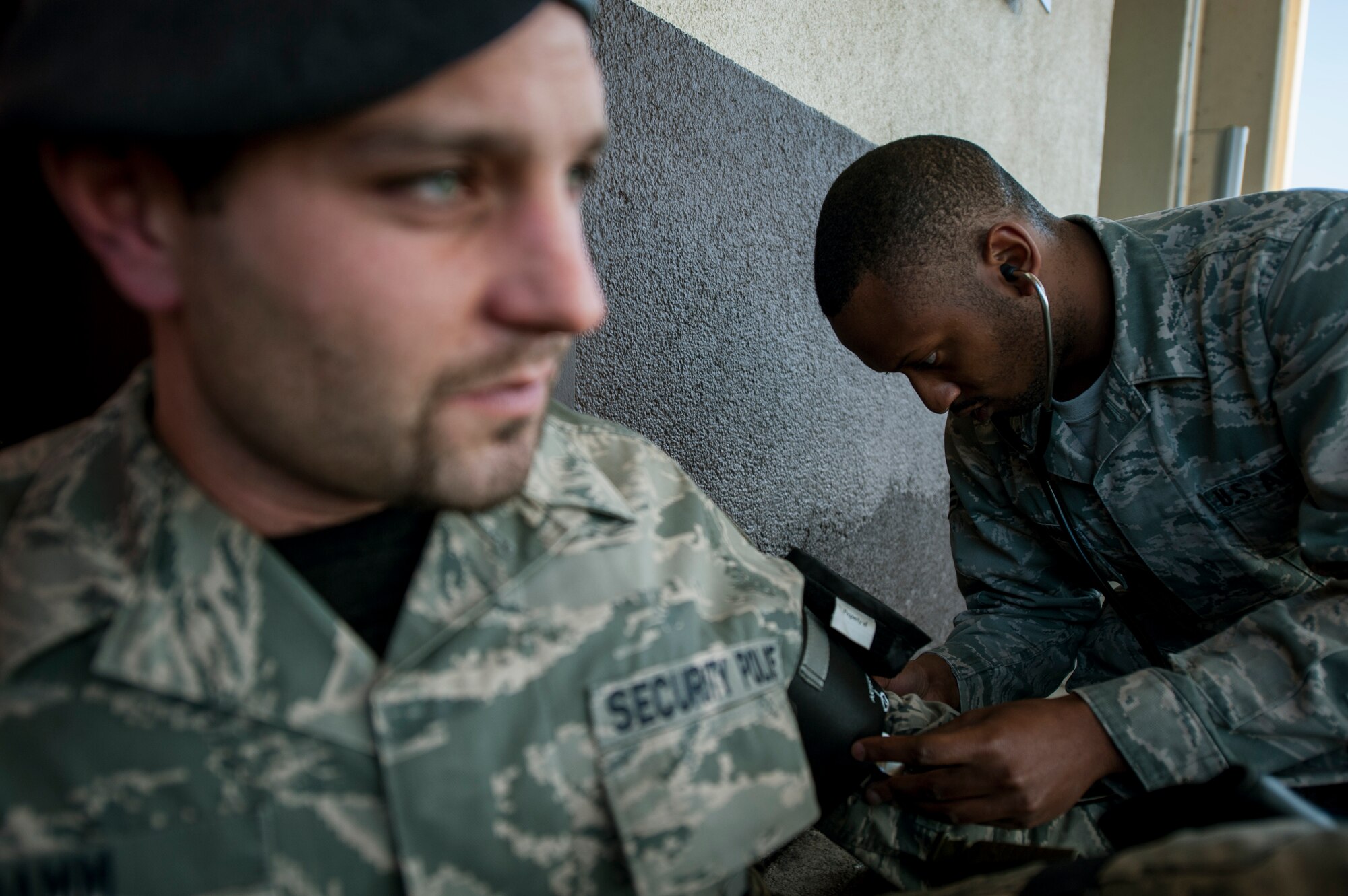 U.S. Air Force Senior Airman Henry Beauchamp, a 52nd Medical Operations Squadron medical technician from Jackson, Miss., takes a patient’s blood pressure during an exercise scenario Oct. 4, 2014, at Spangdahlem Air Base, Germany. For the scenario, first responders simulated treating Beauchamp for a broken leg. (U.S. Air Force photo by Senior Airman Rusty Frank/Released)