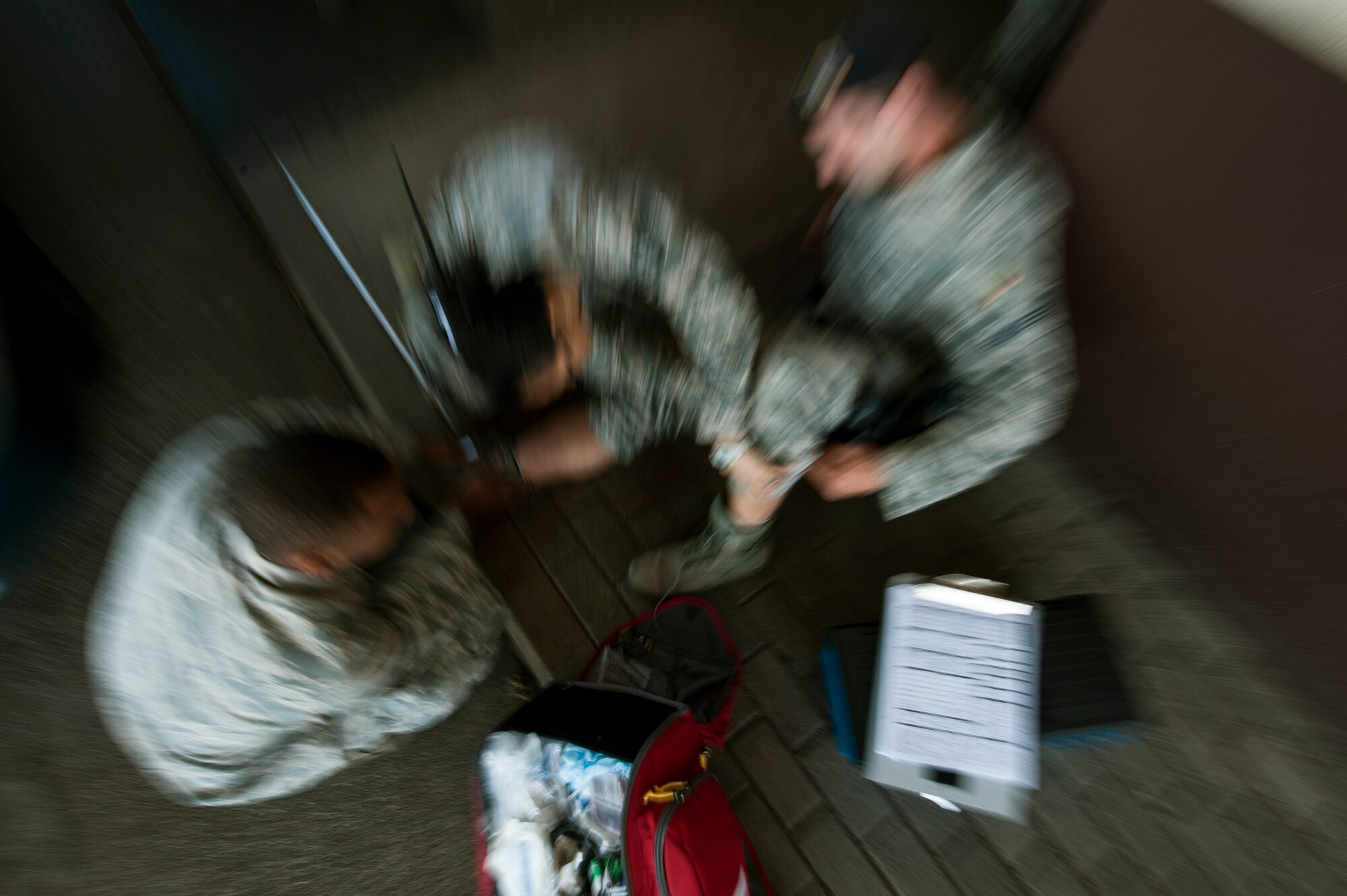U.S. Air Force Tech. Sgt. Maria Pastoral and U.S Air Force Senior Airman Henry Beauchamp, both 52nd Medical Operations Squadron medical technicians, treat a patient during an exercise Oct. 4, 2014, at Spangdahlem Air Base, Germany. The scenario tested the readiness of first responders. (U.S. Air Force photo by Senior Airman Rusty Frank/Released)