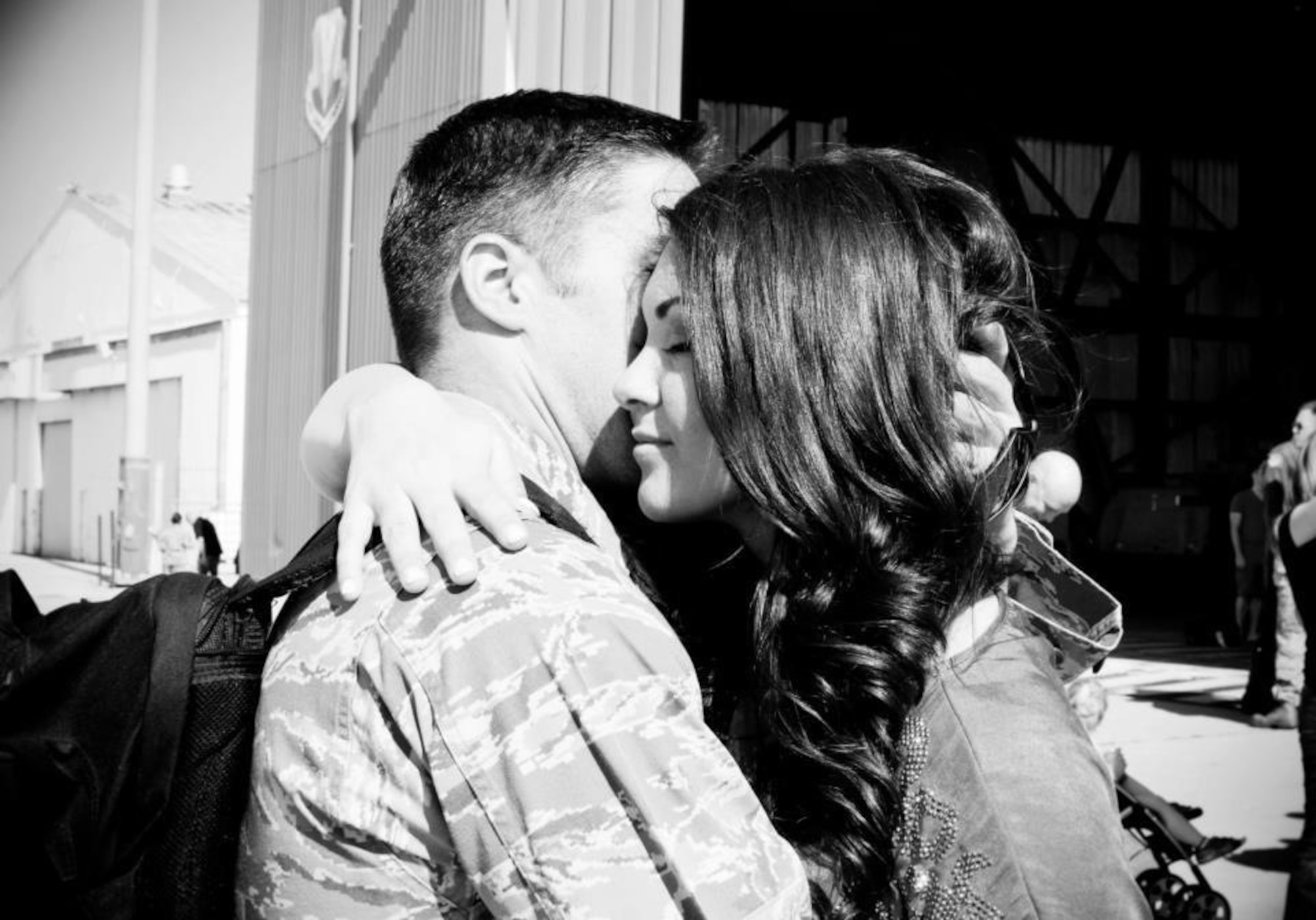U.S. Air Force Capt. Benjamin Griffith, 606th Air Control Squadron alpha flight commander from Bartlett, Tenn., and his wife Christina hug at a military event. The couple has been together for more than four years. (Courtesy photo/Released)