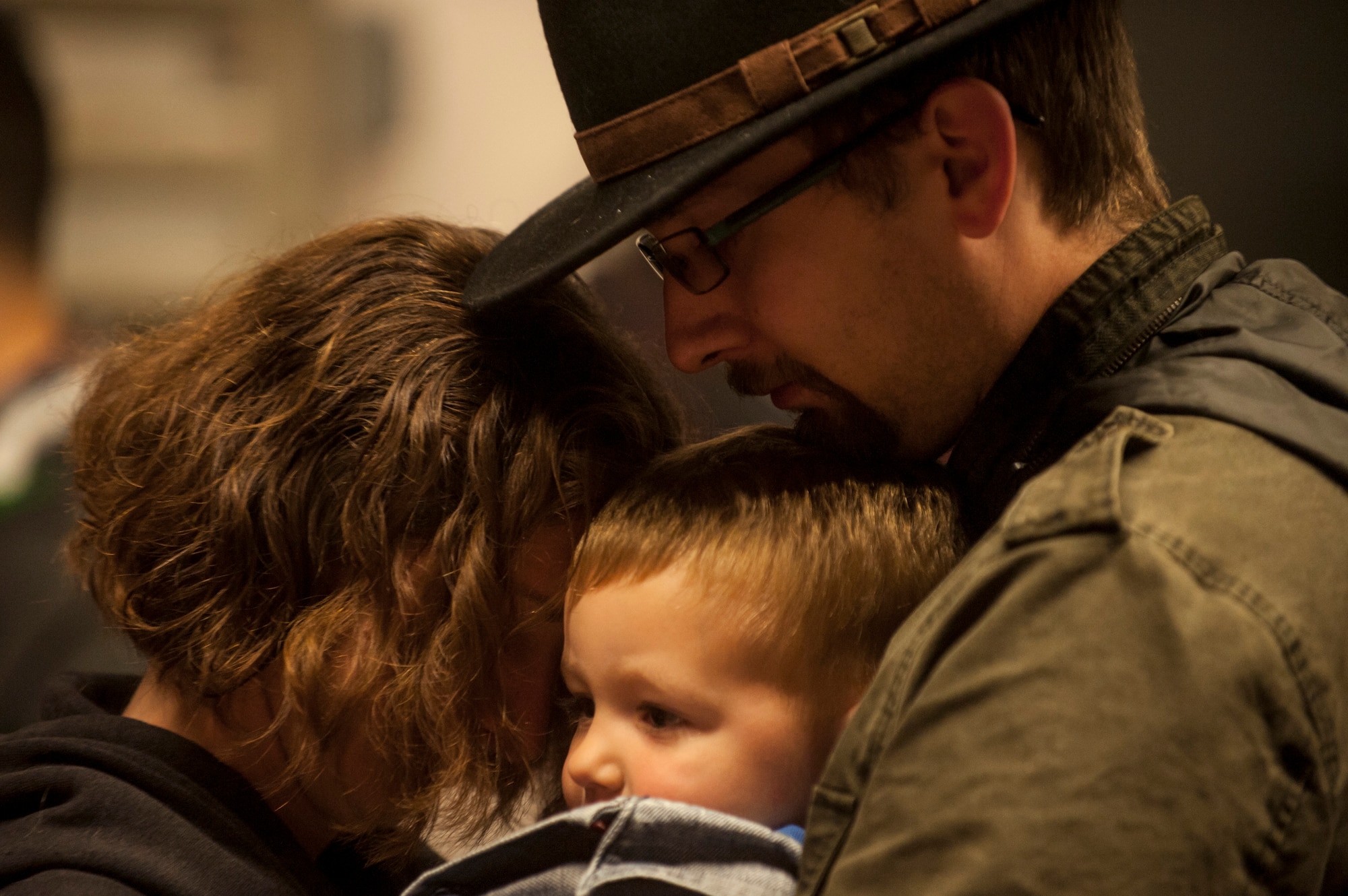 U.S. Air Force Staff Sgt. Amanda Bailey, a 606th Air Control Squadron electronic protection technician, and her husband Chris hold their son William prior to leaving on a deployment Oct. 7, 2014, at Spangdahlem Air Base, Germany. Bailey is one of many Airmen deployed from the 606th ACS to support Operation Enduring Freedom. (U.S. Air Force photo by Senior Airman Rusty Frank/Released)