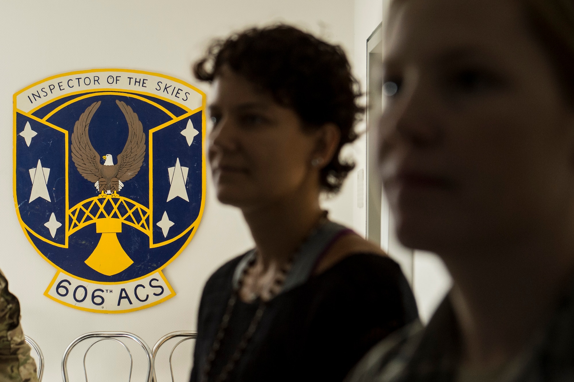 A painted logo of the 606th Air Control Squadron is displayed on the wall during a spouses’ pre-deployment brief Sept. 19, 2014, at Spangdahlem Air Base, Germany. Spouses received pertinent information regarding the unit's deployment during the briefing. (U.S. Air Force photo by Senior Airman Rusty Frank/Released)