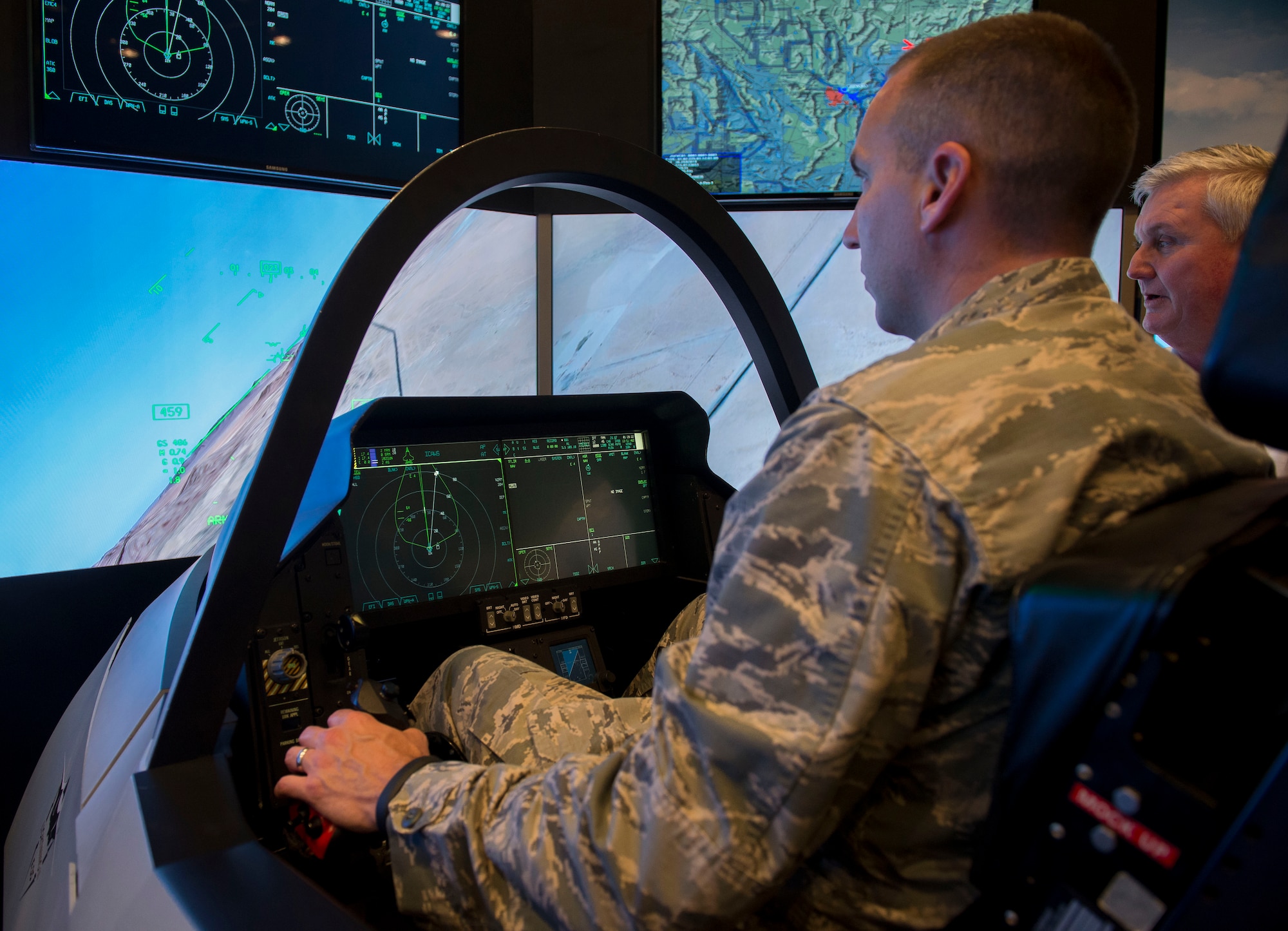 Commander of the Medical Support Squadron, Lt Col. Christopher Estridge, tests out the F-35 Lightning II simulator from Lockheed Martin at Yokota Air Base, Japan, Sept. 29, 2014. Some of the capabilities the F-35 has to offer is it's stealth, sensor information fusion and network-enabled operations. (U.S. Air Force photo by Airman 1st Class Meagan Schutter/Released)