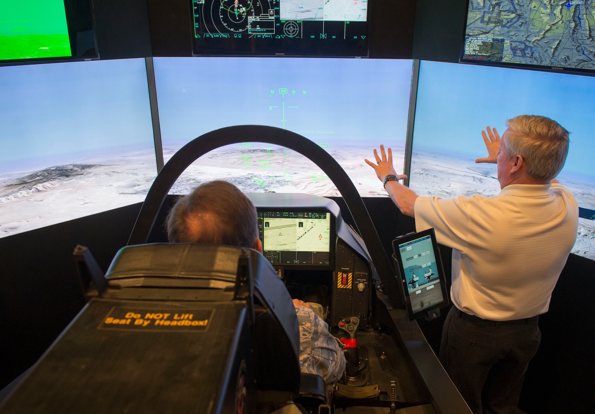 Commander of the 374th Mission Support Squadron, Col. Scott Maskery, pilots the F-35 Lightning II simulator from Lockheed Martin at Yokota Air Base, Japan, Sept. 29, 2014. The F-35 is a 5th Generation fighter, which means all capabilities are enhanced and the technology provides greater survivability, situational awareness, and effectiveness for pilots. (U.S. Air Force photo by Airman 1st Class Meagan Schutter/Released)