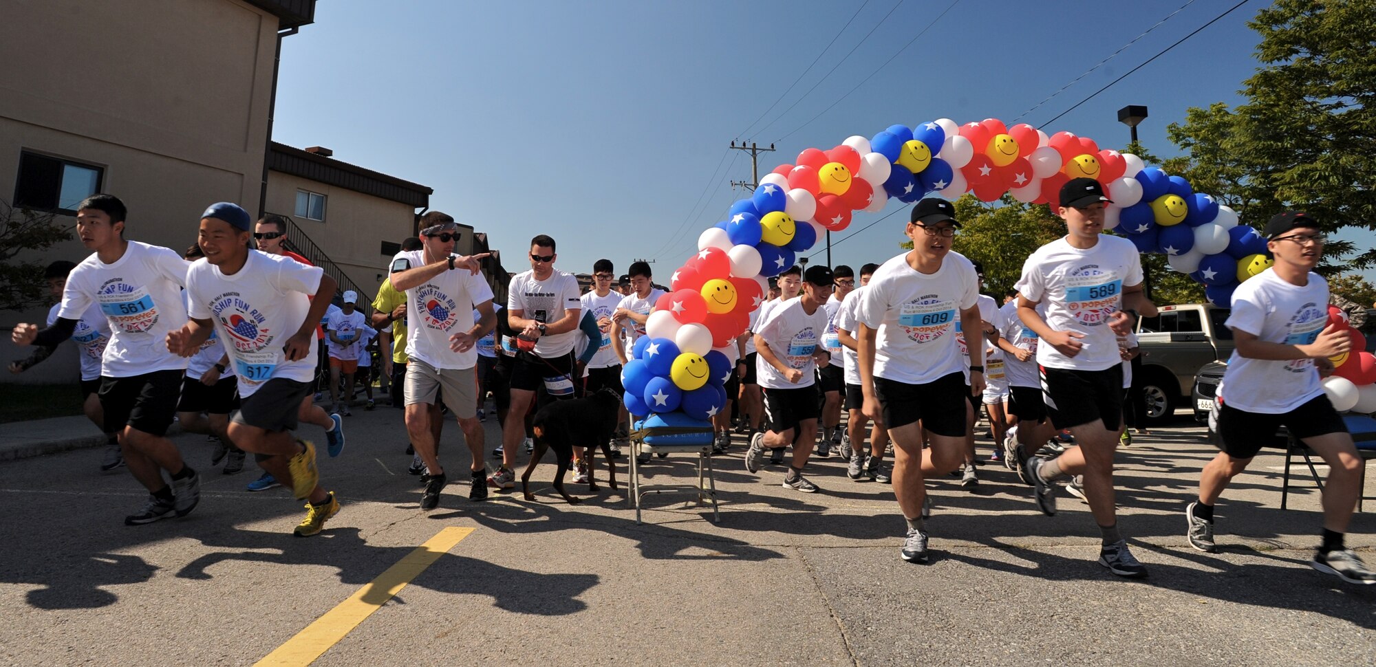 Runners head out during a Friendship Fun Run Oct. 4, 2014 at Osan Air Base, Republic of Korea.  The run was hosted by the 607th Air Operations Center and its Good Neighbors.  More than 300 U.S. and Korean participants registered for the run.  (U.S. Air Force photo by Maj. John Ross)