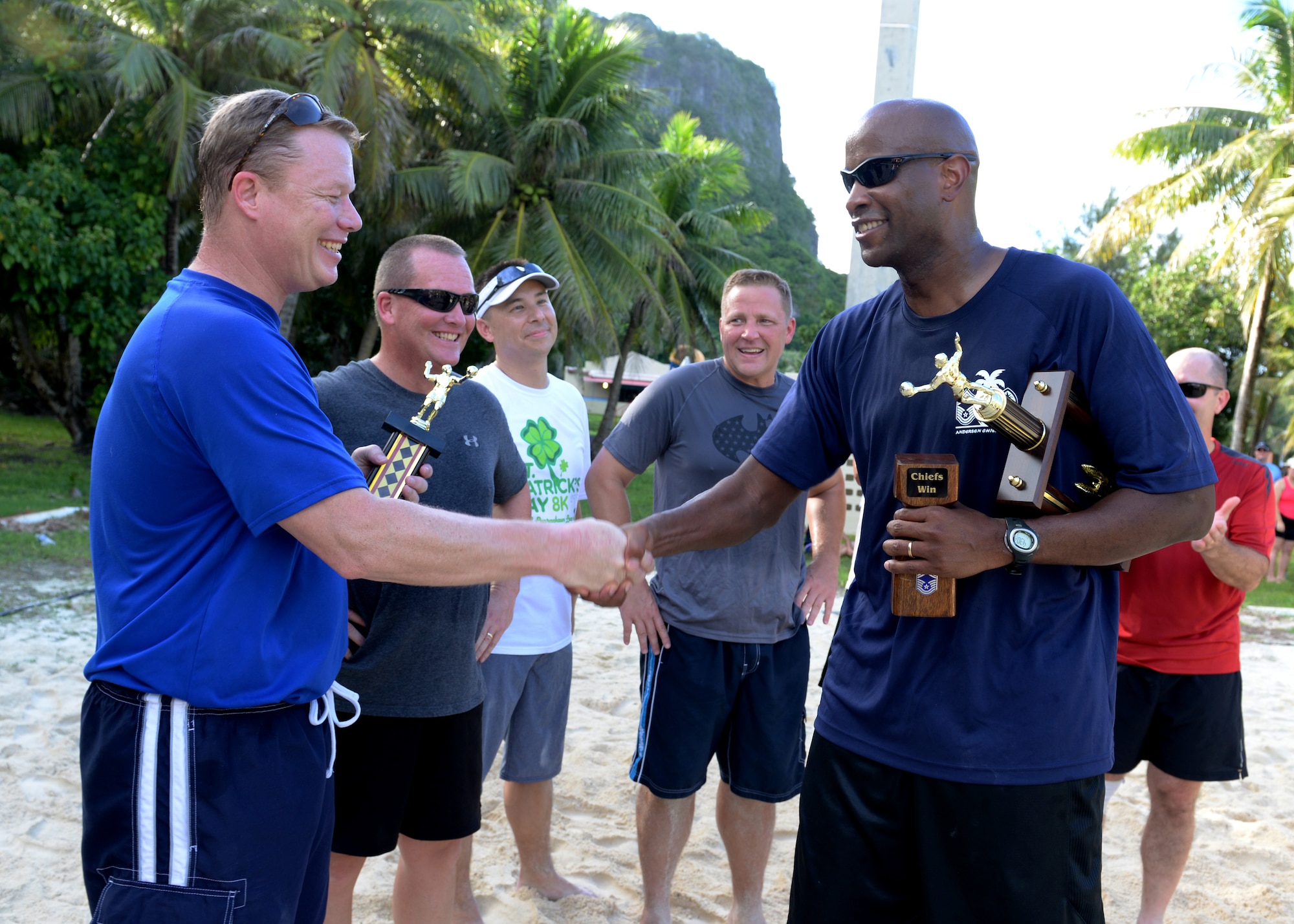 Chief Master Sgt. Michael McMillan, 36th Wing command chief, congratulates Col. John Dunks, 36th Mission Support Group commander, for being the most valuable player during the Chief vs. Eagles volleyball game Oct. 3, 2014, on Andersen Air Force Base, Guam. The game was a part of an ongoing competitive series between the two base leadership groups. (U.S. Air Force photo by Senior Airman Katrina M. Brisbin/Released)