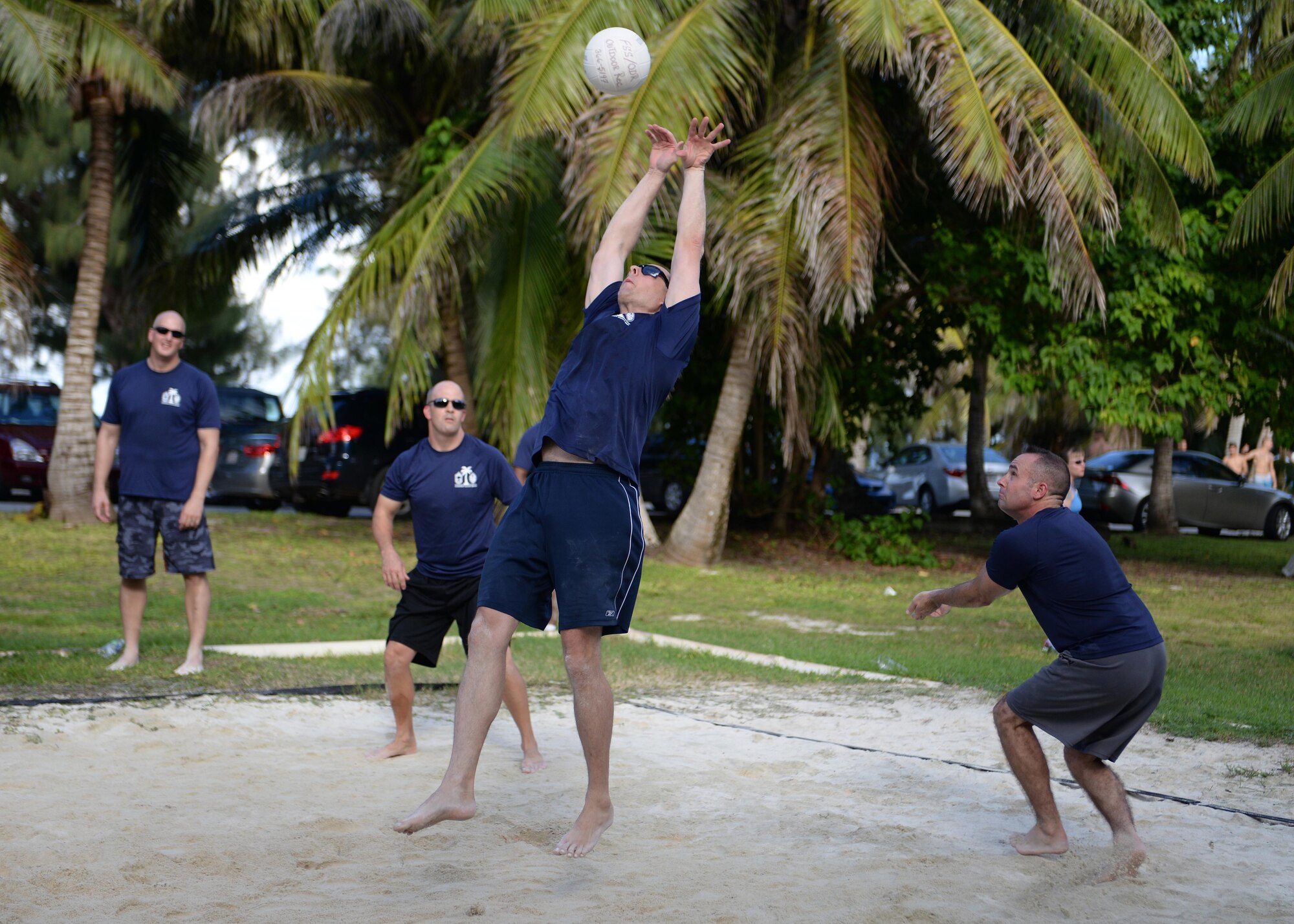 Team Andersen chief master sgts. receive a serve during the Chief vs. Eagles volleyball game Oct. 3, 2014, on Andersen Air Force Base, Guam. The game was a part of an ongoing competitive series  between the two base leadership groups. (U.S. Air Force photo by Senior Airman Katrina M. Brisbin/Released)