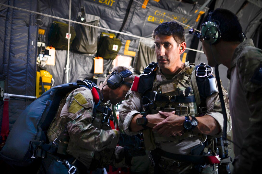 Air Force pararescuemen check their equipment inside an MC-130P Combat Shadow aircraft during Soaring Angel 14 over Fort Hunter Liggett, Calif., Oct. 2, 2014.