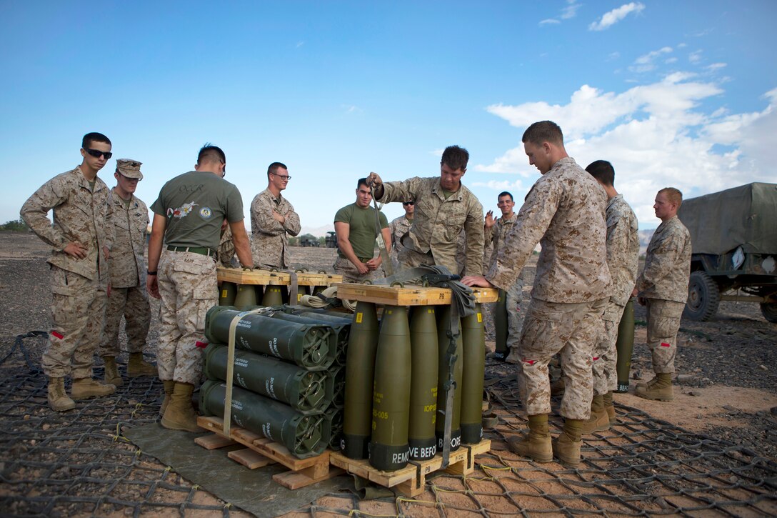 Marines unpack M777 howitzer rounds at Landing Zone Bull on Chocolate Mountain Aerial Gunnery Range, Calif., Sept. 27, 2014.