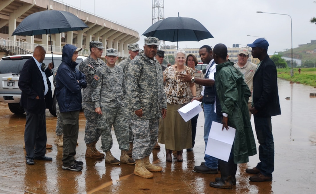 U.S. Army Maj. Gen. Darryl A. Williams, commander of U.S. Army Africa, and U.S. Ambassador to Liberia Deborah R. Malac speak to James Nebleeh, the project superintendent, at Samuel K. Doe stadium in Monrovia, Liberia, Sept. 23, 2014, where crews are constructing an Ebola treatment unit. 