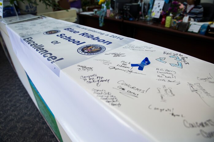 A banner sits inside the front office of Matthew C. Perry Elementary School aboard Marine Corps Air Station Iwakuni, Japan, Oct. 7, 2014. Visitors can sign the banner to celebrate M. C. Perry Elementary winning the title of National Blue Ribbon School. Only two Department of Defense Education Activity schools received the honor this year; Aukamm Elementary School in Germany and M. C. Perry Elementary.  