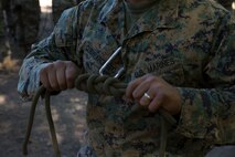 Staff Sergeant Marvin Guerraromero, the Company Gunnery Sereant of Tansportation and Service Company, Combat Logistics Battalion 6, shows his example of a square knot, Oct 2. Marines from CLB-6 and 2nd Battalion, 5th Marine Regiment attended the Summer Mountain Exercise aboard Matine Corps Mountain Warfare Training Center that spans a total of 21 says and teaches them how to survive in trecherous mountain terrain.(U.S. Marine Corps photo by LCpl. Preston McDonald/Released)