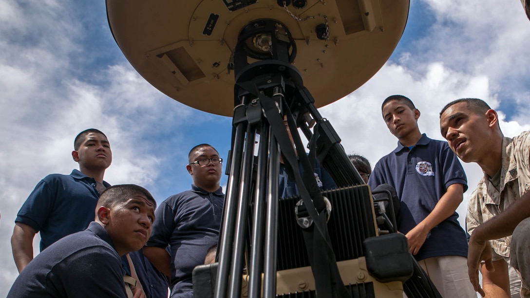 Cpl. Giovani Perezvargas showcases a device used by air traffic controllers to Okkodo High School’s Marine Corps Junior Reserve Officers’ Training Corps cadets Oct. 3 during Forager Fury III. Perezvargas is an air traffic controller navigational aids technician with detachment B, Marine Air Control Squadron 4, Marine Air Control Group 18, 1st Marine Aircraft Wing, III Marine Expeditionary Force. The cadets were provided the opportunity to witness some of the different tools used by Marine Corps air traffic controllers. 