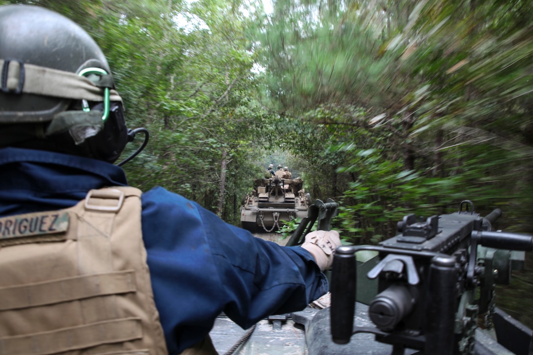 A Marine with 2nd Maintenance Battalion, 2nd Marine Logistics Group, keeps watch as a group of M88A2 Hercules Recovery Vehicles patrol along a trail in the woods on the way to perform a recovery operation training exercise aboard Marine Corps Base Camp Lejeune, N.C., Sept. 29, 2014. The Hercules can tow and rescue other vehicles, weighing up to 70 tons, using a winch and pulley system. Marines and sailors with the battalion conducted a field exercise Sept. 18-Oct. 1, 2014, to reinforce their ability to accomplish battalion-level, mission essential tasks.