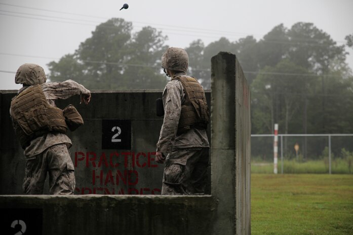 Corporal Orry Kraczek, a heavy equipment mechanic with 2nd Maintenance Battalion, 2nd Marine Logistics Group, and Rice Lake, Wis., native, tosses a practice hand grenade prior to live-fire training with the M67 Fragmentation Hand Grenade aboard Marine Corps Base Camp Lejeune, N.C., Sept. 25, 2014.  Practicing grenade throws helps Marines gain confidence in using the M67 in a combat situation. Marines and sailors with the battalion conducted a field exercise Sept. 18-Oct. 1, 2014, to reinforce their ability to accomplish battalion-level, mission essential tasks.