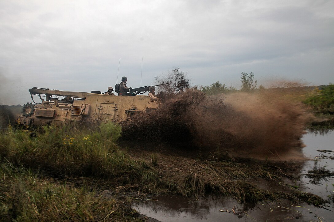 An M88A2 Hercules Recovery Vehicle from 2nd Maintenance Battalion, 2nd Marines Logistics Group, splashes into a pool of mud in an attempt to get stuck for recovery training aboard Camp Lejeune, N.C., Sept. 29, 2014.  Marines recovered a Hercules from an 8-foot deep mud pool using a winch and pulley system. Marines and sailors the battalion conducted a field exercise Sept. 18-Oct. 1, 2014, to reinforce their ability to accomplish battalion-level, mission essential tasks.