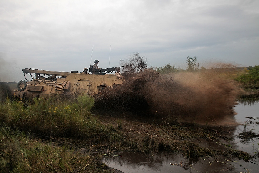 An M88A2 Hercules Recovery Vehicle from 2nd Maintenance Battalion, 2nd Marines Logistics Group, splashes into a pool of mud in an attempt to get stuck for recovery training aboard Camp Lejeune, N.C., Sept. 29, 2014.  Marines recovered a Hercules from an 8-foot deep mud pool using a winch and pulley system. Marines and sailors the battalion conducted a field exercise Sept. 18-Oct. 1, 2014, to reinforce their ability to accomplish battalion-level, mission essential tasks.