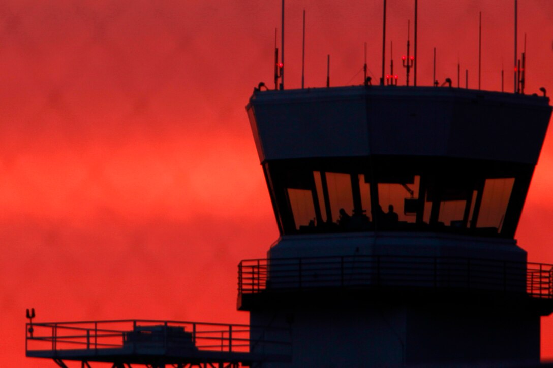 The air traffic control tower at Marine Corps Air station Cherry Point, N.C., sits silhouetted against the rising sun Oct. 7, 2014. Cherry Point is home to the 2nd Marine Aircraft Wing and its runways operate 24/7, 365 days each year. 