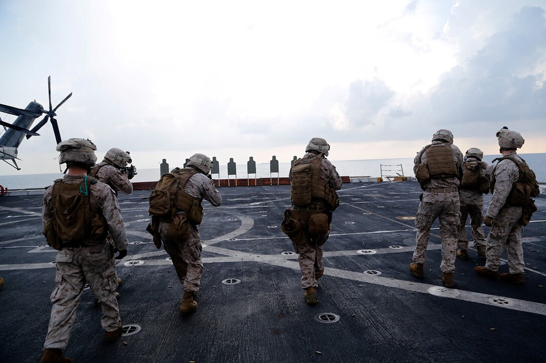 U.S. Marines with Fox Company, Battalion Landing Team 2nd Battalion, 1st Marines (BLT 2/1), 11th Marine Expeditionary Unit (MEU), fire on the move during a Table 3 combat marksmanship course of fire as a part of sustainment training on the flight deck of the USS San Diego (LPD 22), Oct. 1. The 11th MEU is a forward-deployed, flexible sea-based Marine Air-Ground Task Force embarked with the Makin Island Amphibious Ready Group in the U.S. 5th Fleet area of responsibility. (U.S. Marine Corps photos by Gunnery Sgt. Rome M. Lazarus/ Released)  