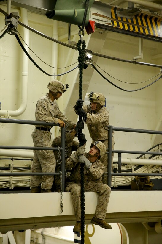 U.S. Marines with Battalion Landing Team 2nd Battalion, 1st Marines, 11th Marine Expeditionary Unit (MEU), practice team fast-roping techniques in the well deck of the USS San Diego (LPD 22), Oct. 7. Marines from the 11th MEU are deployed with the Makin Island Amphibious Ready Group as a flexible, adaptable and persistent force in the U.S. 5th Fleet area of responsibility. (U.S. Marine Corps photo by Cpl. Jonathan R. Waldman/ Released)