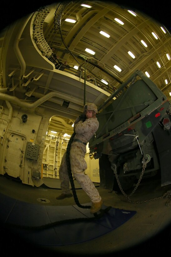 U.S. Marine Corps Lance Cpl. Ronald I. Montgomery, a mortarman with Battalion Landing Team 2nd Battalion, 1st Marines, 11th Marine Expeditionary Unit (MEU), and a native of Clearwater, Florida, braces for landing during fast-roping practice in the well deck of the USS San Diego (LPD 22), Oct. 7. The 11th MEU is a forward-deployed, flexible sea-based Marine Air-Ground Task Force embarked with the Makin Island Amphibious Ready Group in the U.S. 5th Fleet area of responsibility. (U.S. Marine Corps photo by Cpl. Jonathan R. Waldman/Released)