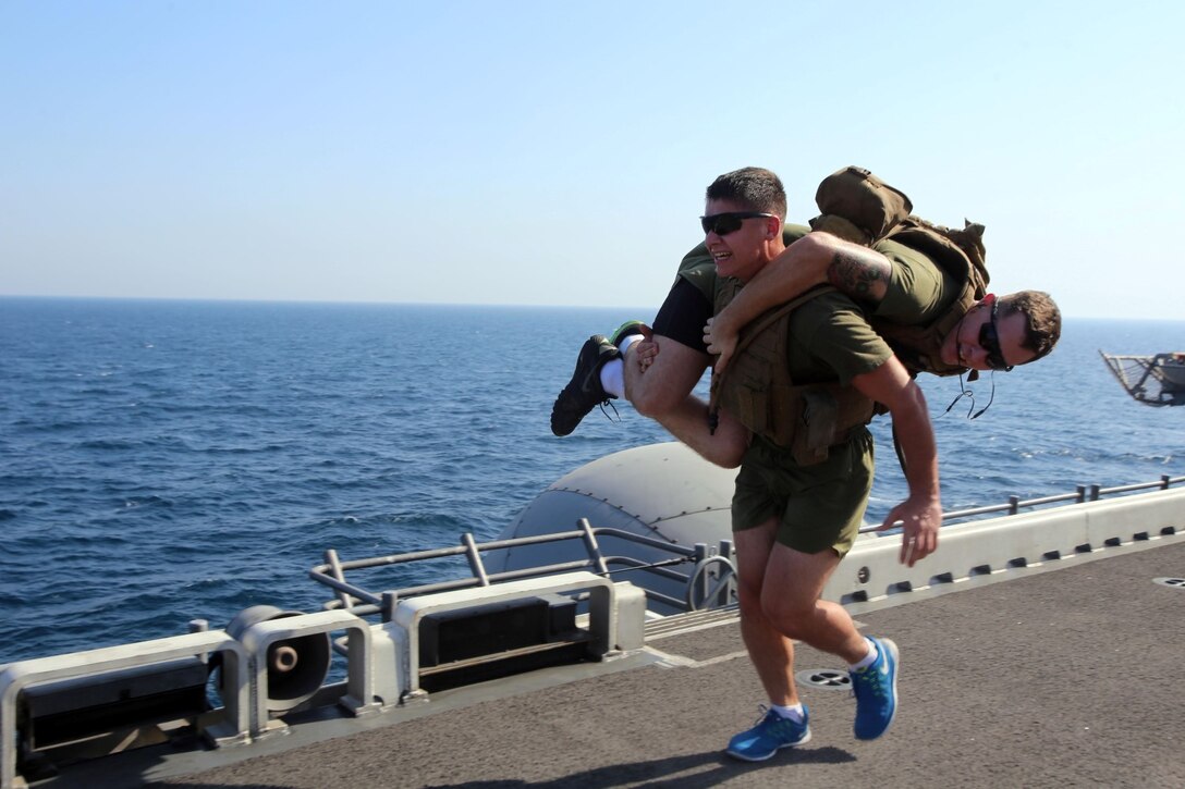 Lance Cpl. Justin M. Corduan, a machinegunner with Fox Company, Battalion Landing Team 2nd Battalion, 1st Marines (BLT 2/1), 11th Marine Expeditionary Unit (MEU), and San Diego native, fireman carries Lance Cpl. Tyler J. Potter, a machinegunner with Fox Co. BLT 2/1, 11th MEU, and Mount Washington, Kentucky native, aboard the USS Makin Island (LHD 8), Oct. 7. The 11th MEU is deployed with the Makin Island Amphibious Ready Group as a theater reserve and crisis response force throughout U.S. Central Command and the U.S 5th fleet area of responsibility. (U.S. Marine Corps photo by Cpl. Demetrius Morgan/RELEASED)