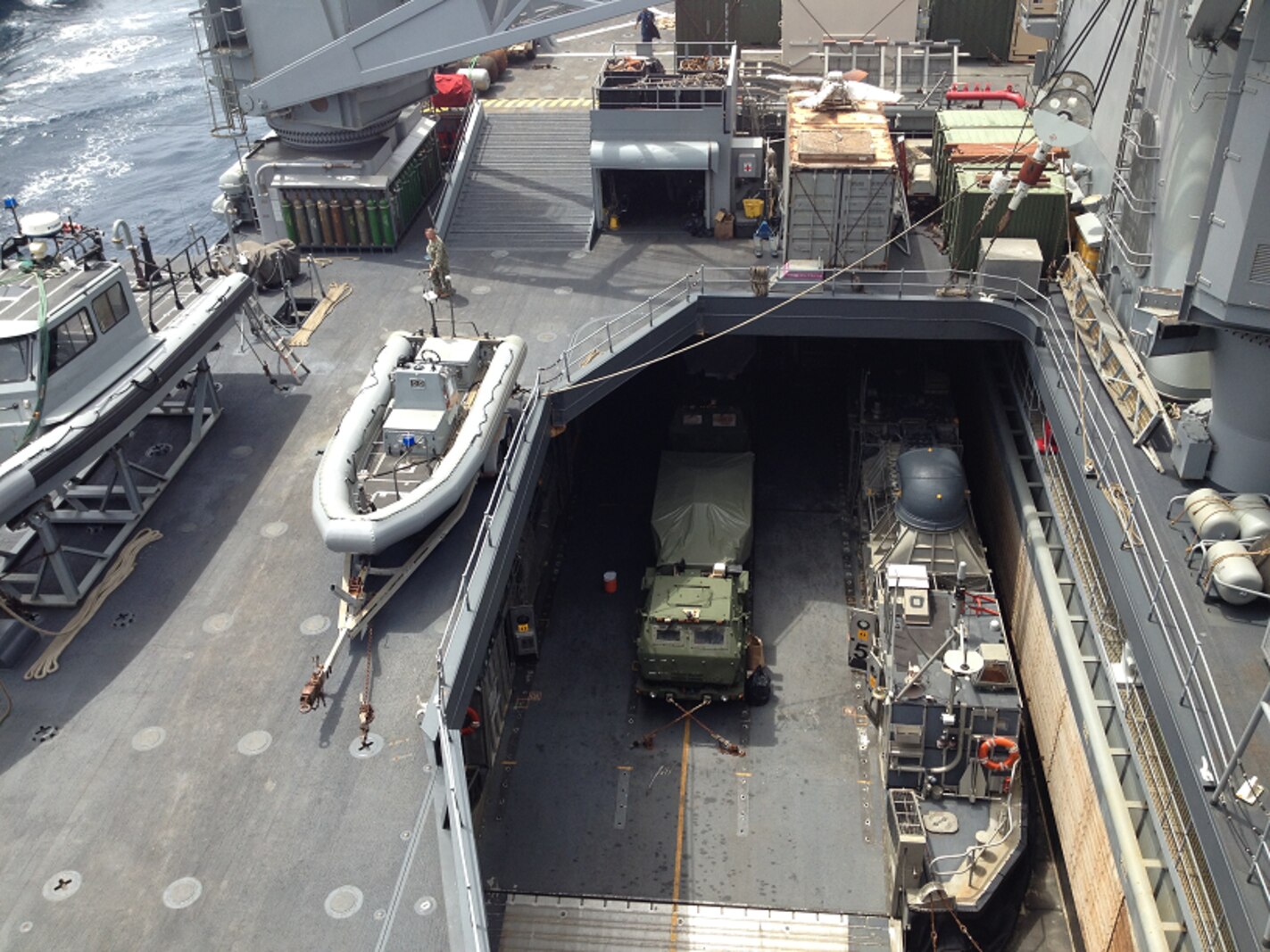 A M142 HIMARS launcher from Battery R can be seen chained to an LCAC in the well deck of the USS Rushmore (LSD-47) while underway.